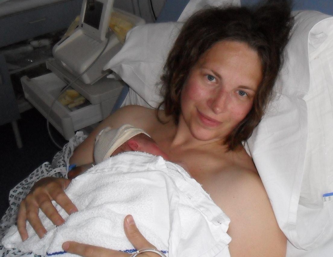 Beautiful mum just after giving birth with her baby skin to skin