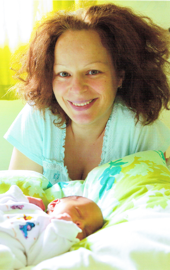 Beautiful mum with baby smiling after birth