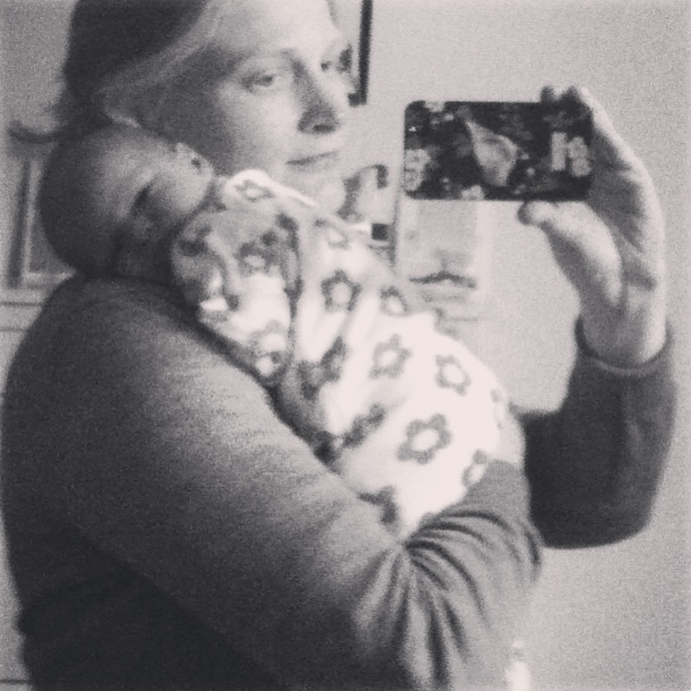 Black and white selfie photo. Mum with baby daughter sleeping on her shoulder